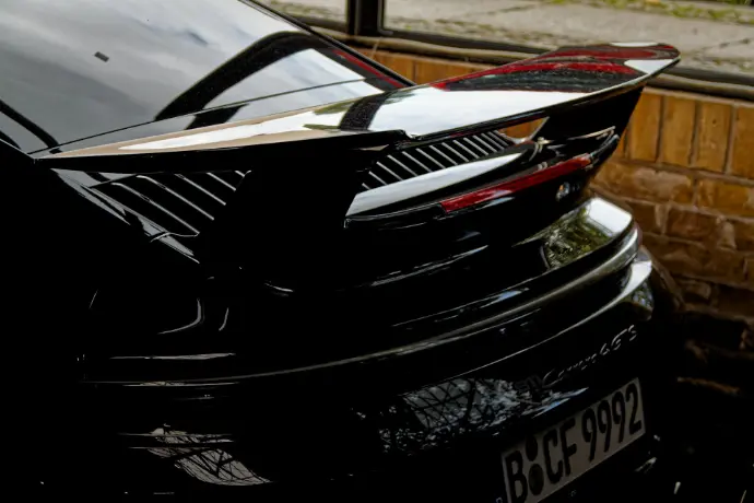a close up of a car with a surfboard on top of it
